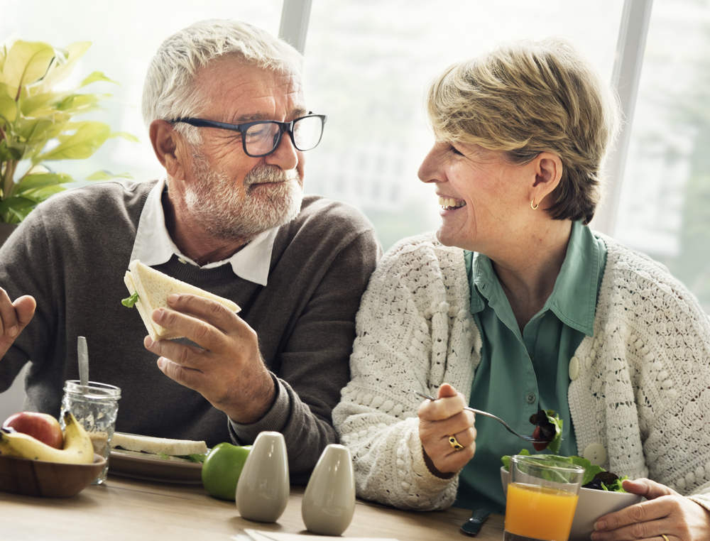 Senior Couple with permanent denture eating food