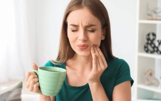 Lady squinting form tooth sensitivity