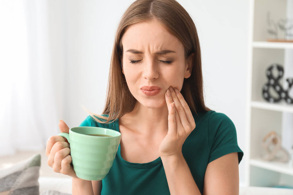 Lady squinting form tooth sensitivity